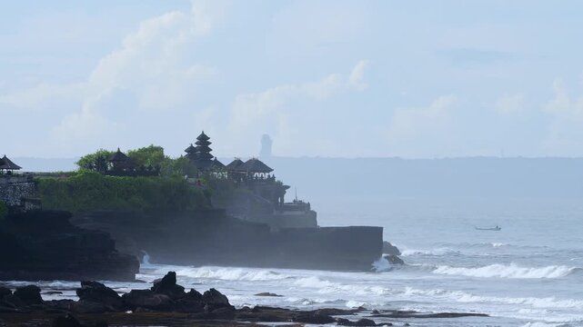 Oceanfront Sacred Site Exploration. Excursion To Holy Site Amid Crashing Waves And Dark Skies. Exploring Revered Religious Landmark Situated Along Tumultuous Ocean Shoreline Tanah Lot, Bali