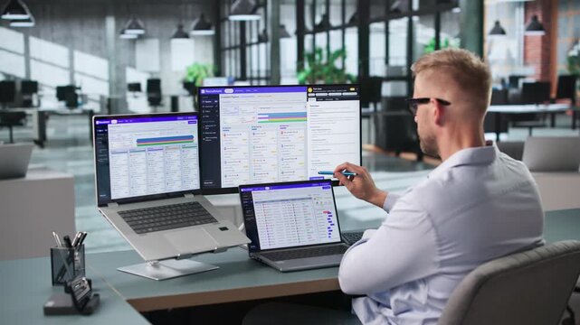 Recruiter Reviews Candidate Resumes On Laptop