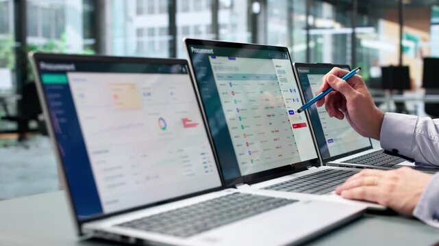 Business Analyst Reviewing Procurement Data On Laptop