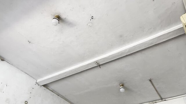 Dirty home ceiling with mold stains and light fixture