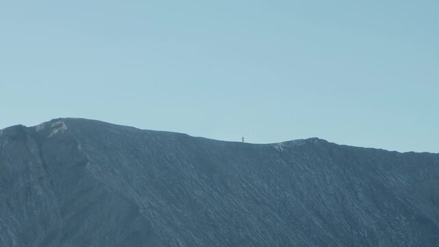 Runner moving along the edge of Mount Bromo in Indonesia