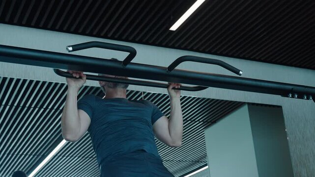 Man sportsman do pullup exercise. Muscular biceps and triceps. Strong athlete. Man pullup in gym. 4k footage. Muscular man sportsman with strong muscle. Sport pullup workout. Sport training