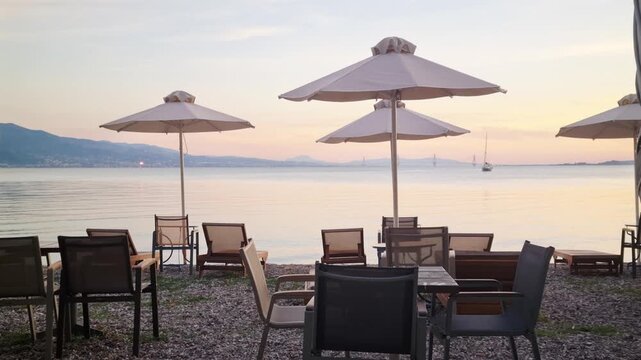 Serene Beach Club Sunbeds and Parasols at Sunset with Rio Antirrio Bridge Horizon