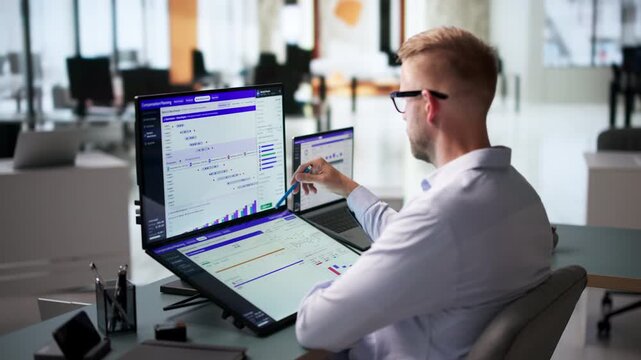 HR Analyst Reviews Compensation Dashboard On Laptop