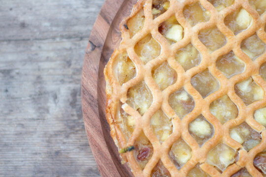 Close Up of Homemade Apple Pie with Golden Lattice Crust and Rustic Pastry Texture
