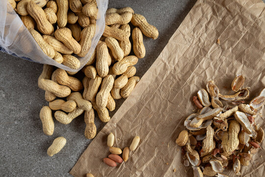 whole peanuts and broken shells top view
