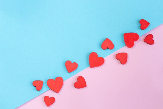 Red Paper Hearts on Pink and Blue Pastel Background for Valentine's Day