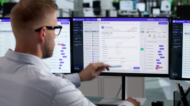 Recruiter Reviews Candidate Resumes On Laptop