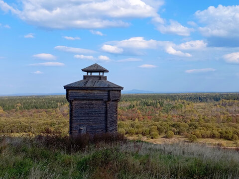 Wooden watchtower on the hillside in the autumn forest in Cherdyn, Russia
