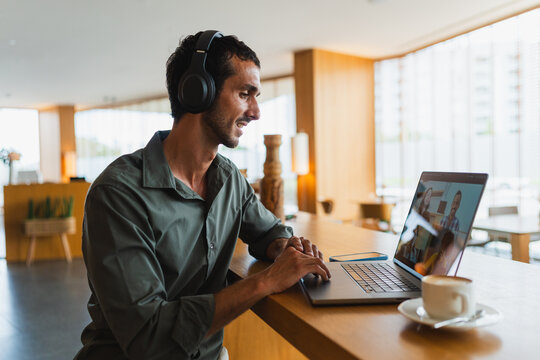 Man participating in video conference call using laptop