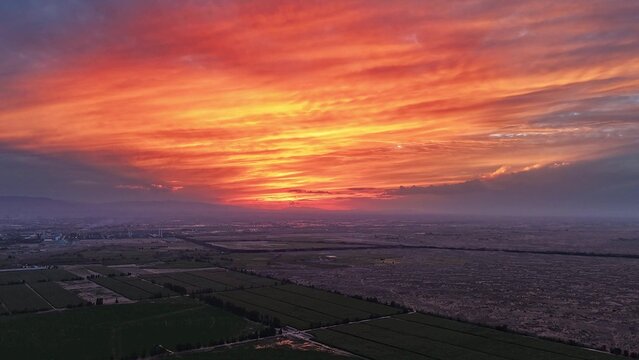 Brilliant sunset clouds over vast farmland fields