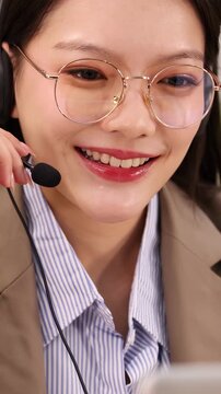 Asian Businesswoman with Headset Talking on Customer Support Video Call