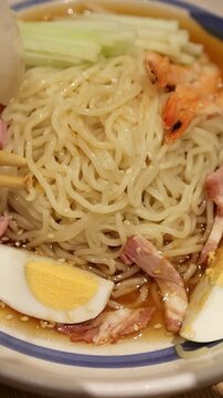 Close Up of Chilled Ramen Noodles with Shrimp and Boiled Egg