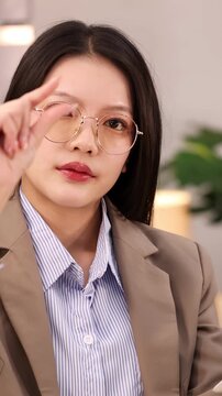 Asian Businesswoman Interacting with Virtual Screen in Office