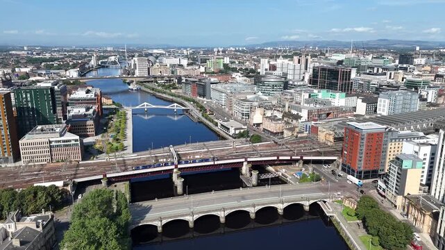 Glasgow Central railway station and bridges spanning the River Clyde, showing the transport infrastructure and riverside architecture that shape the city centre of Glasgow, Scotland.