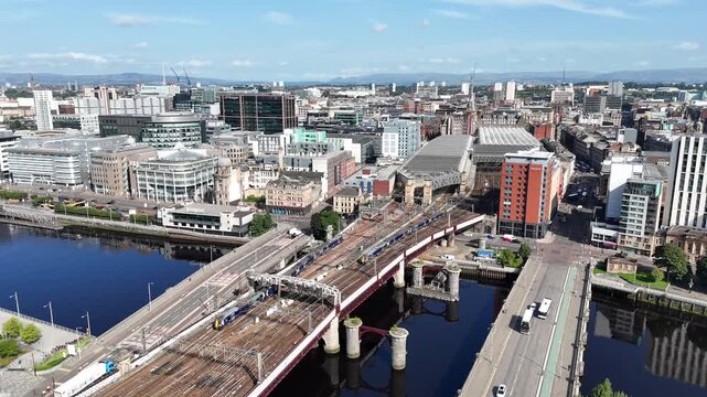 Glasgow Central railway station and bridges spanning the River Clyde, showing the transport infrastructure and riverside architecture that shape the city centre of Glasgow, Scotland.