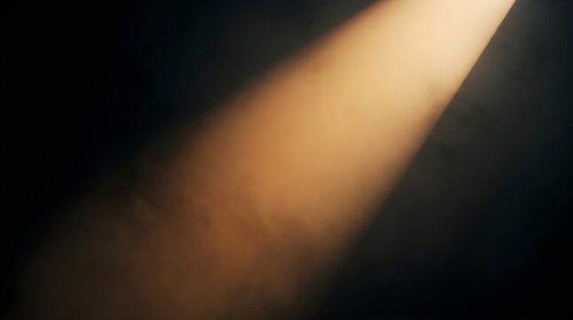 Diagonal amber light beam illuminates dark atmospheric background