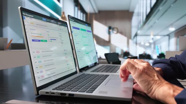 Risk Manager Carefully Analyzes Data On Laptop