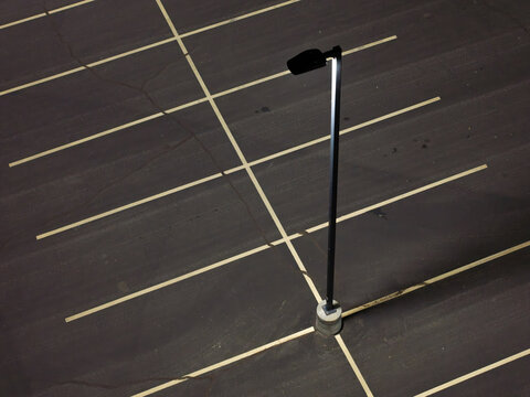 Dark asphalt parking lot with crisp white lines