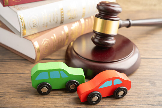 Car accident lawsuit and insurance, Judge hammer with car model.