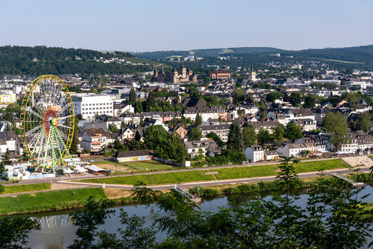 The cityscape of Trier features the Moselle river and a ferris wheel