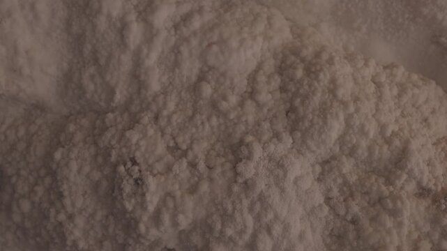 The salt cave walls on Qeshm Island feature textured mineral and crystalline salt formations. Close-up view of natural geological patterns and underground deposits. ProRes 422, 10-bit, C-Log video..