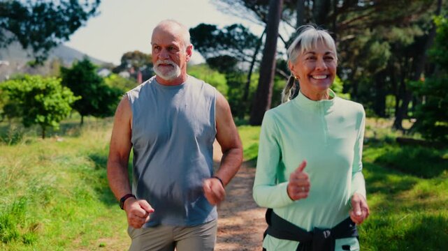 Walking, happy and senior couple in park for wellness, exercise and active for healthy lifestyle. Marriage, retirement and woman with man on nature path for fresh air, cardio workout and mobility
