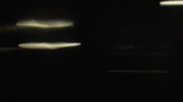 Subtle warm light leak overlay with bright lens flare streaks, designed for seamless blending modes in modern video editing workflows.