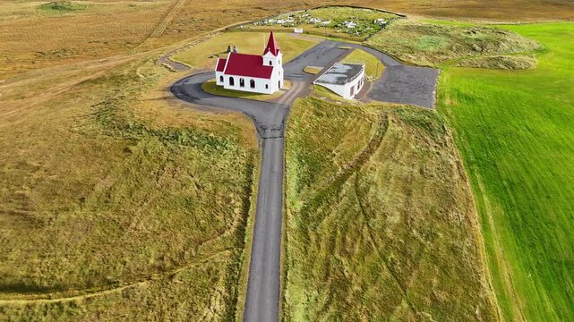 Aerial view of the Ingjaldsh&oacute;ll Church with parish house and cemetry on the Sn&aelig;fellsnes Peninsula, Iceland, September 2026.