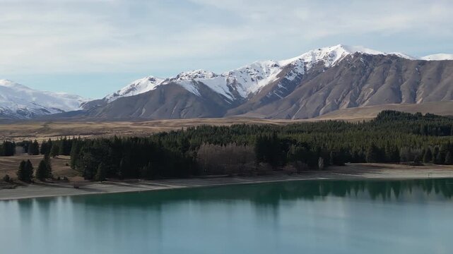 Aerial view of Lake Tekapo New Zealand reveals stunning mountain landscapes with beautiful blue water, Southern Alps peaks and peaceful natural scenery for travel tourism