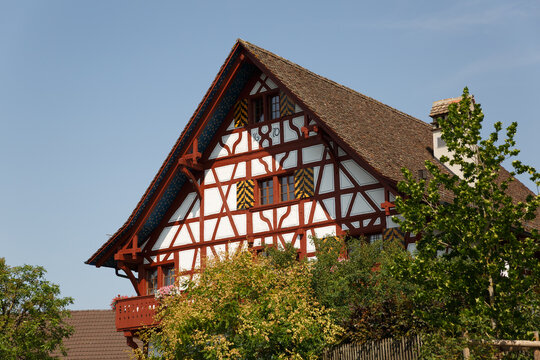 Historic red half-timbered house dated 1670 with painted shutters and a star-decorated gable, Eglisau, Switzerland