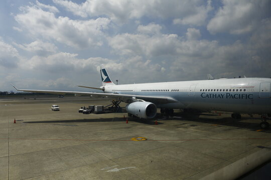 Commercial passenger airplane parked at airport tarmac apron.