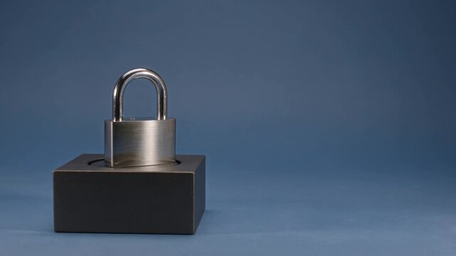 Metal padlock against a dark blue background