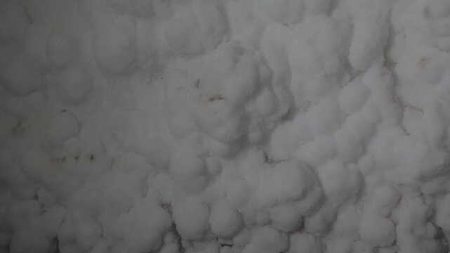 The salt cave walls on Qeshm Island feature textured mineral and crystalline salt formations. Close-up view of natural geological patterns and underground deposits. ProRes 422, 10-bit, C-Log video..