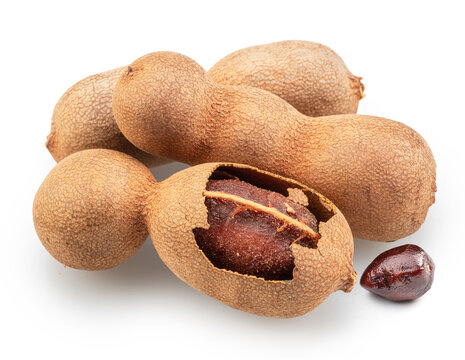  Cluster of fresh tamarind pods and several shelled tamarind see