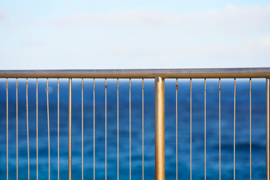 Metal fence overlooking ocean in outdoor coastal setting at Oahi
