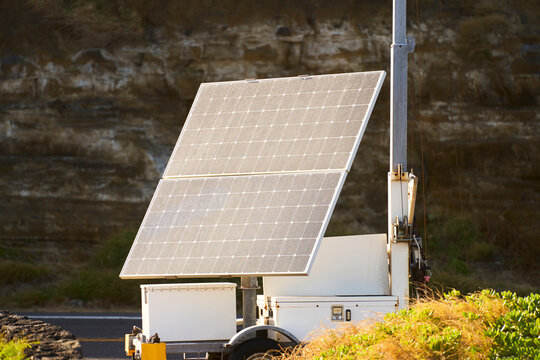 Solar panels mounted on trailer base capturing sunlight outdoors