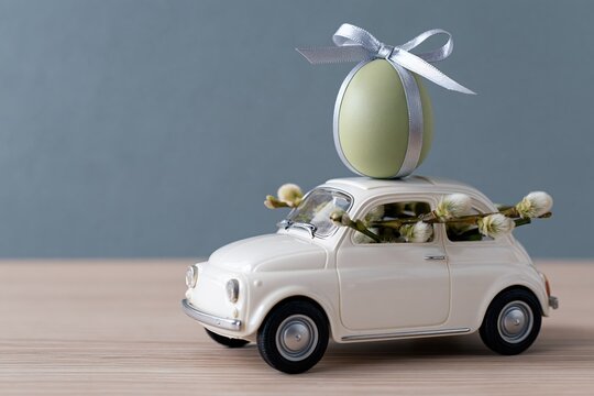 The Gift Egg on a Tiny Vintage Car Adorned with Garland