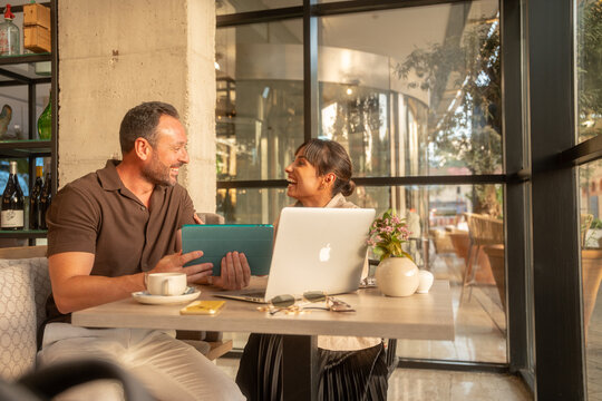 Coworkers having a business meeting with laptop and tablet