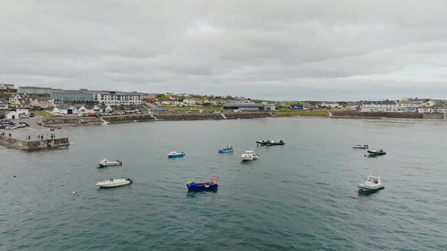 Kilkee Ireland aerial view reveals a beautiful coastal town with sandy beach waterfront tourist houses Atlantic Ocean marina boats and scenic European travel