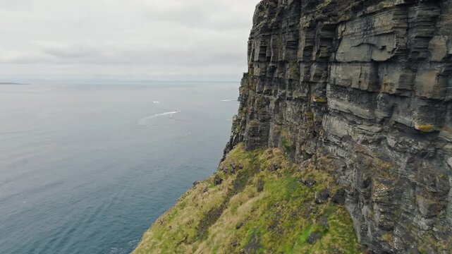 Cliffs Moher Ireland aerial view reveals towering Atlantic coastal rocks and powerful ocean waves creating breathtaking natural scenery and famous European tourist attraction