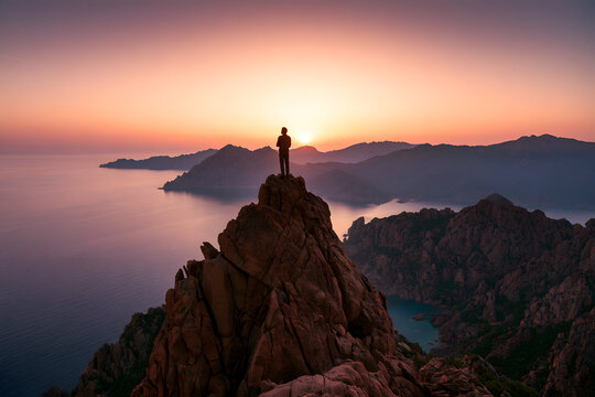 A solitary traveler revels in the golden hues of the sunset over the sea, perched atop a mountain in Corsica. Mission accomplished, a fresh start for 2023. Calanques de Piana