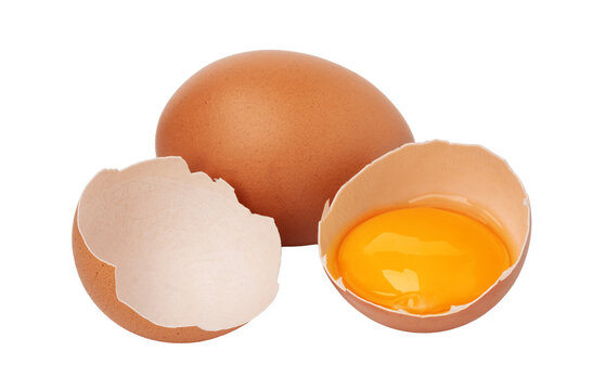 Broken eggshell with yolk and whole egg on a white background