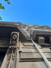 Low-angle photo of a classic stone building facade with carved reliefs © Bat-seba