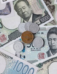 Japanese yen money notes and coins on table. Japan cash bills of JPY currency close up © Marharyta