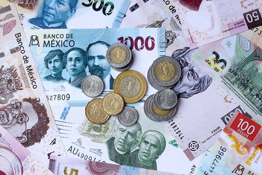 Mexican peso money notes and coins on table. Mexico cash bills of MXN currency close up