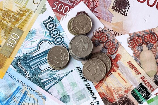 Russian ruble money notes and coins on table. Russian cash bills of RUB currency close up