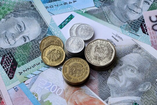 Peruvian sol money notes and coins on table. Peru cash bills of PEN currency close up