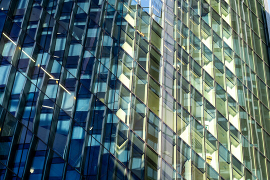 Reflective glass windows create abstract architecture where blue and yellow pattern fills the facade and texture repeats across the reflective glass windows