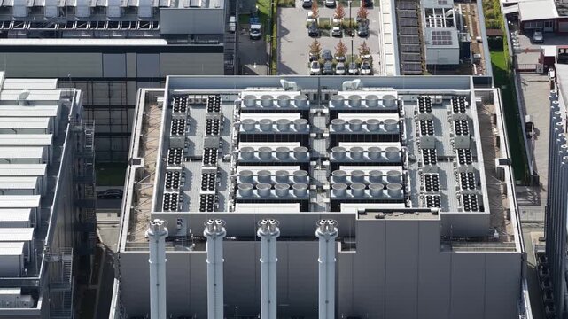 Aerial view of large HVAC cooling systems on a data center rooftop, supporting cloud computing, artificial intelligence, big data, machine learning and critical IT infrastructure.